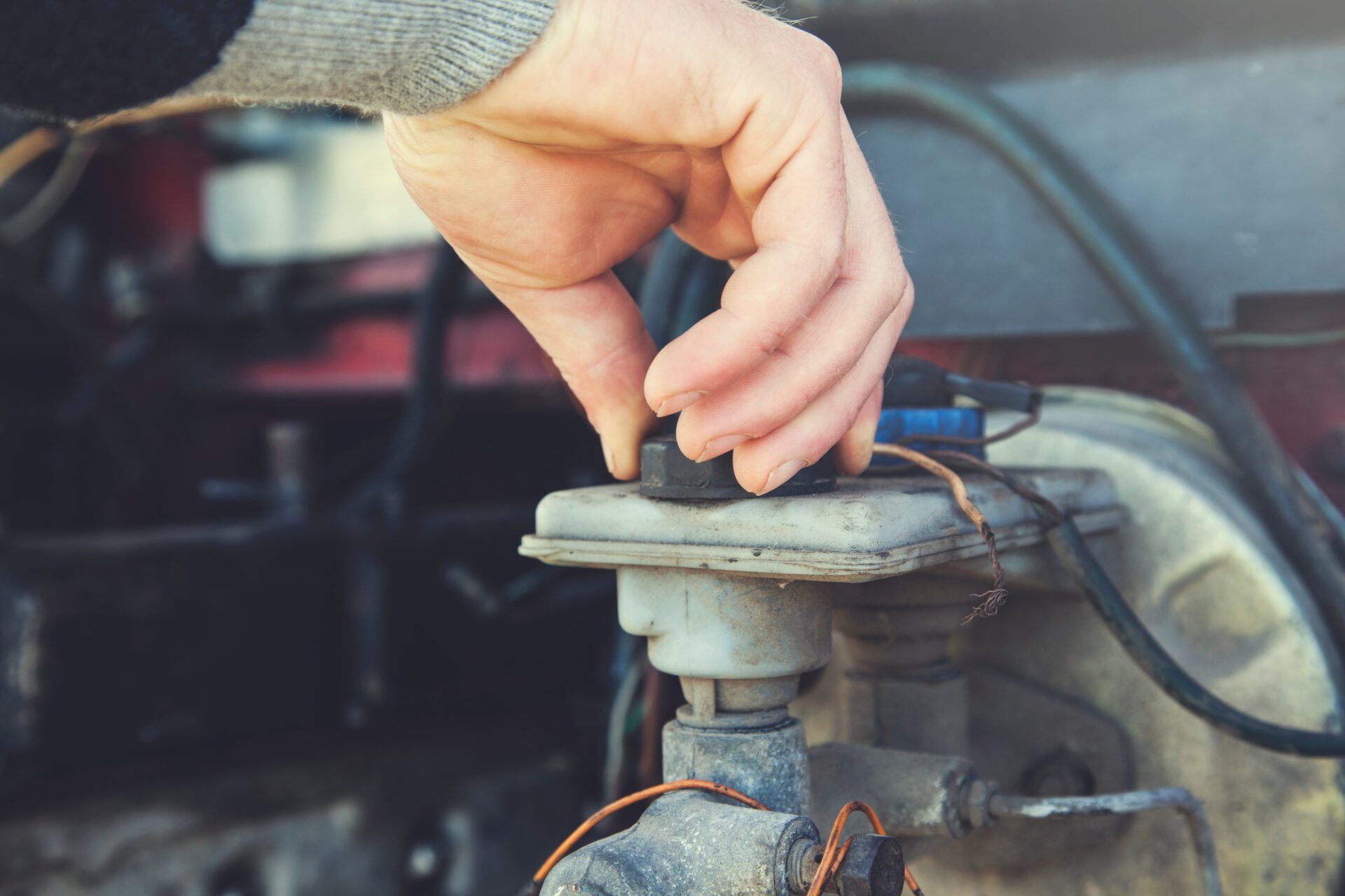 the young worker man hand car oil